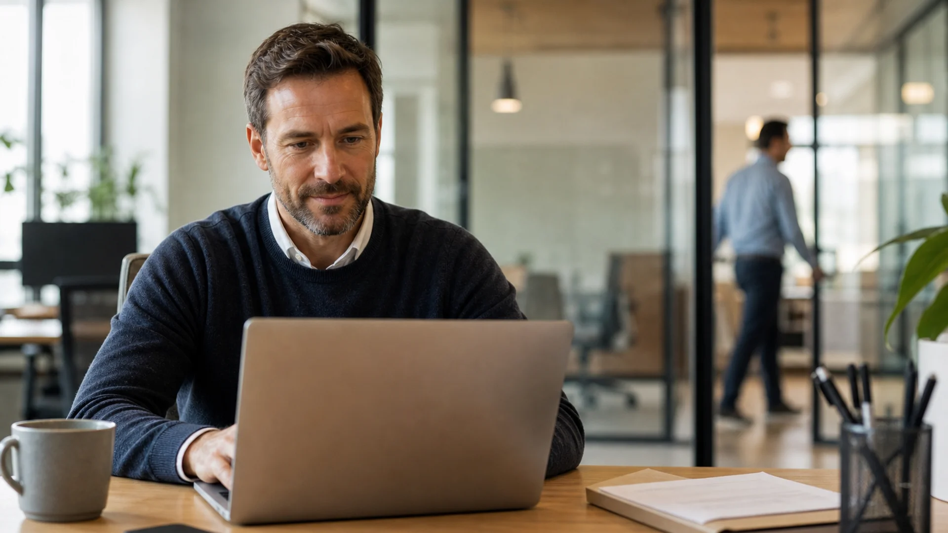 Customer and Partner Portals for B2B Operations Operations manager using a B2B customer portal on a laptop in a professional office with warm natural daylight